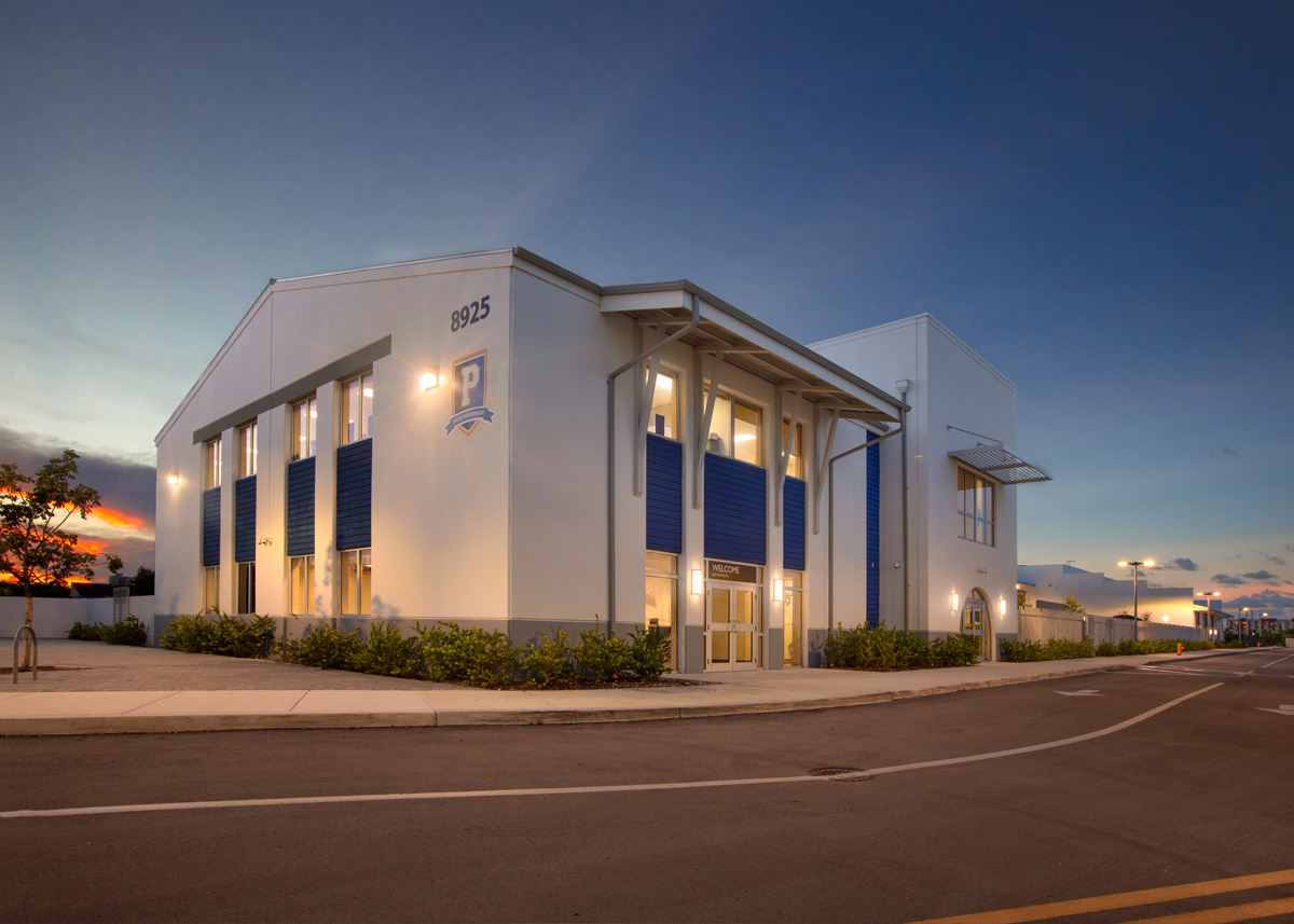 Architectural dusk view of the Pinecrest prep charter k-12 school in Miami.